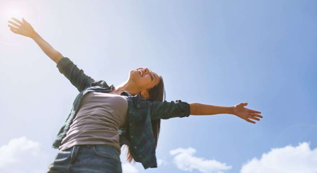 Praising the day. Portrait of an attractive young woman celebrating the day outside.